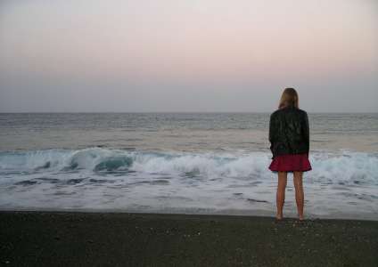 A girl on the beach in full growth